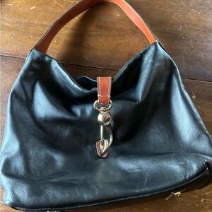 Sleek Dooney & Bourke  Black Hobo Bag with Brown Leather Strap